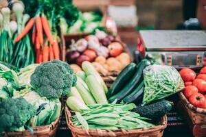 Image of baskets of produce. Items include carrots, green beans, zucchini, tomatoes, broccoli, apples